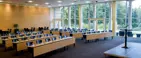 Talerstol i et stort konferencelokale med udsigt til natur opstillet som sildeben